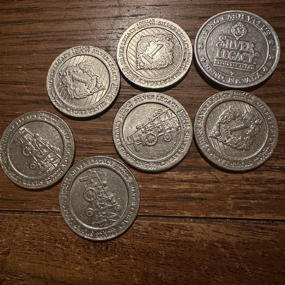 6 Silver Legacy $1 Gaming Tokens and 1 of no value